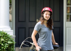 Smiling girl with braces riding her bike