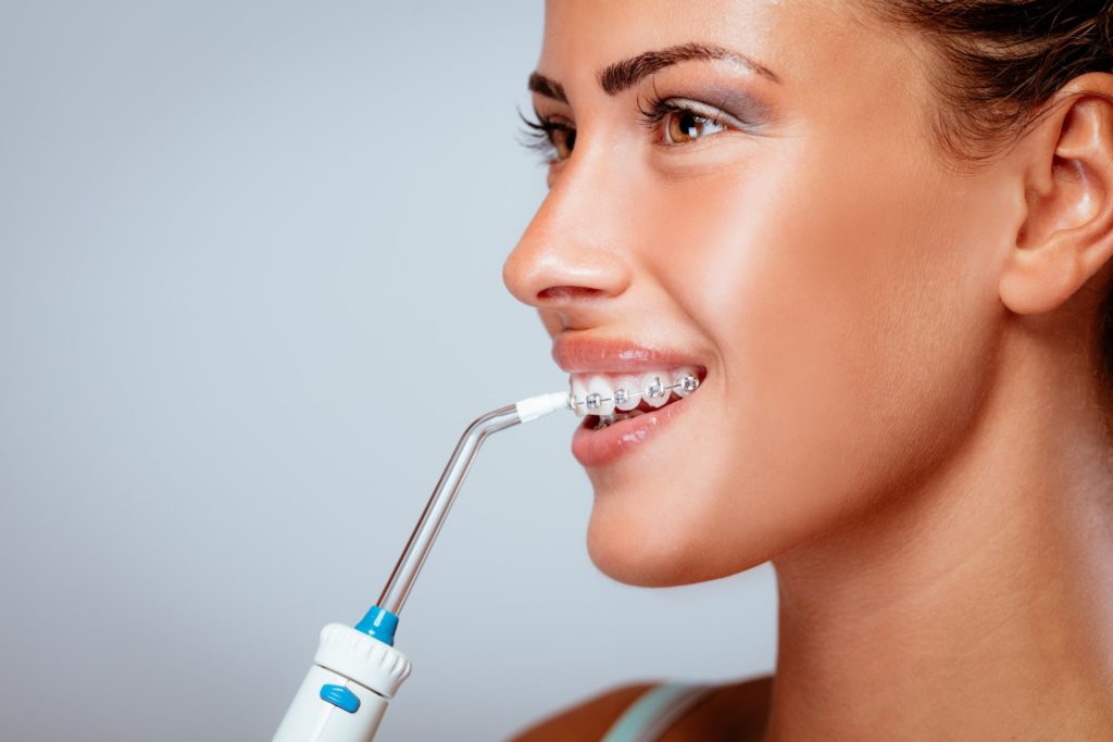 women using water flosser