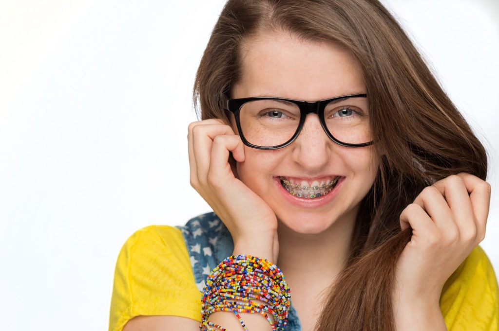 Teen girl with glasses smiling