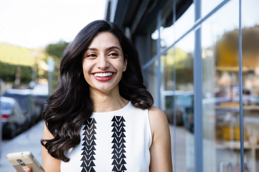 Women walking down the street smiling