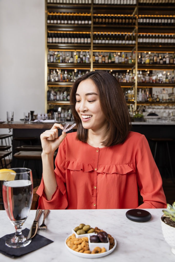 Lady in cafe with Invisalign 