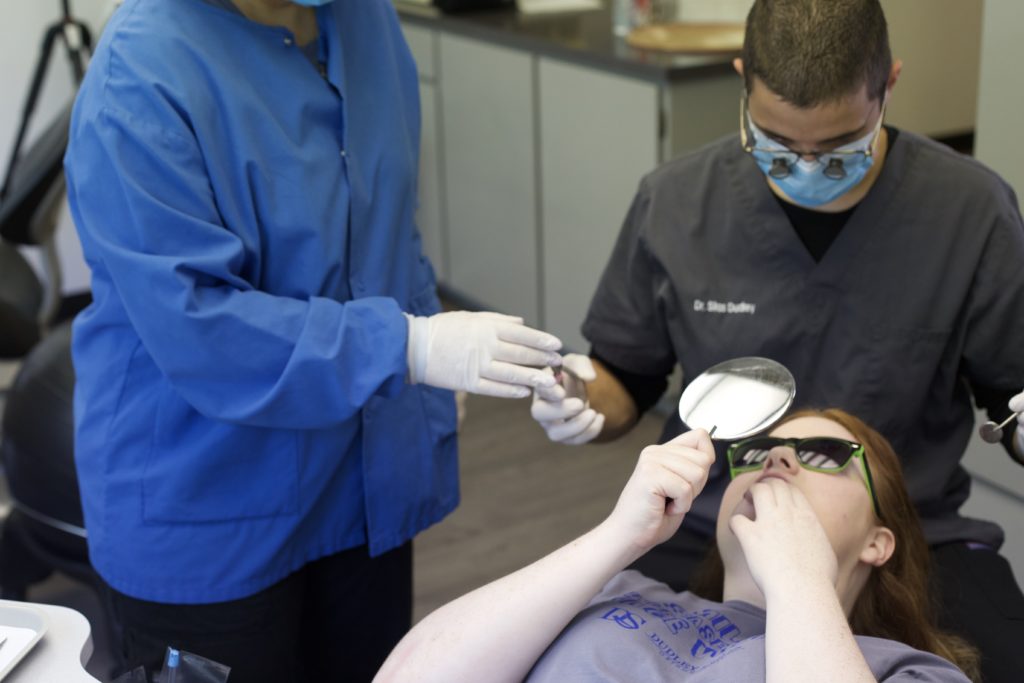 Dudley patient looking at her braces