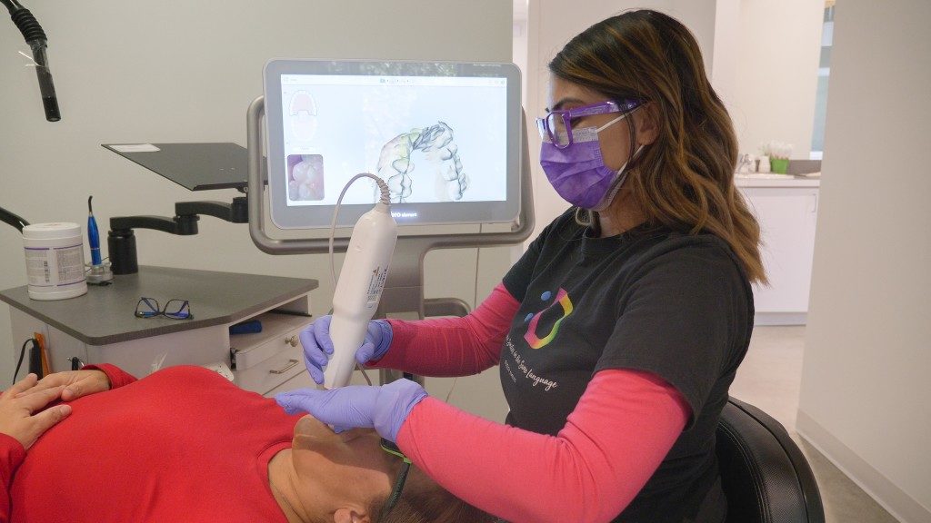 Dudley assistant scanning patient's teeth