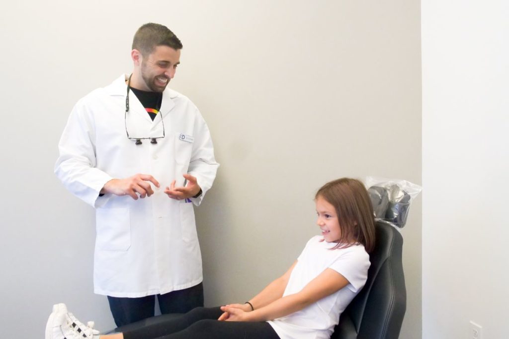 Dr. Silas talking to a young patient