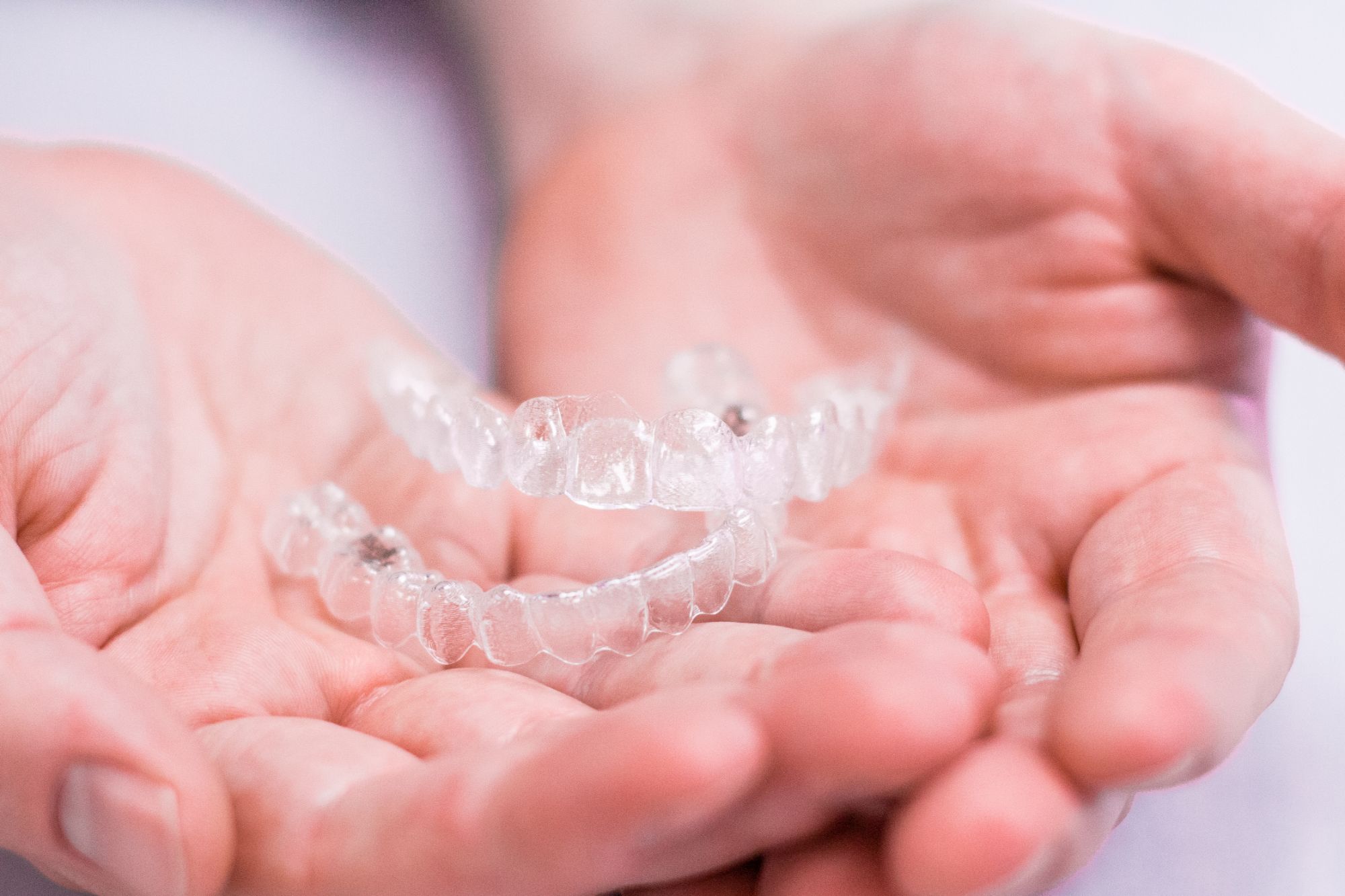 hands holding invisalign aligner