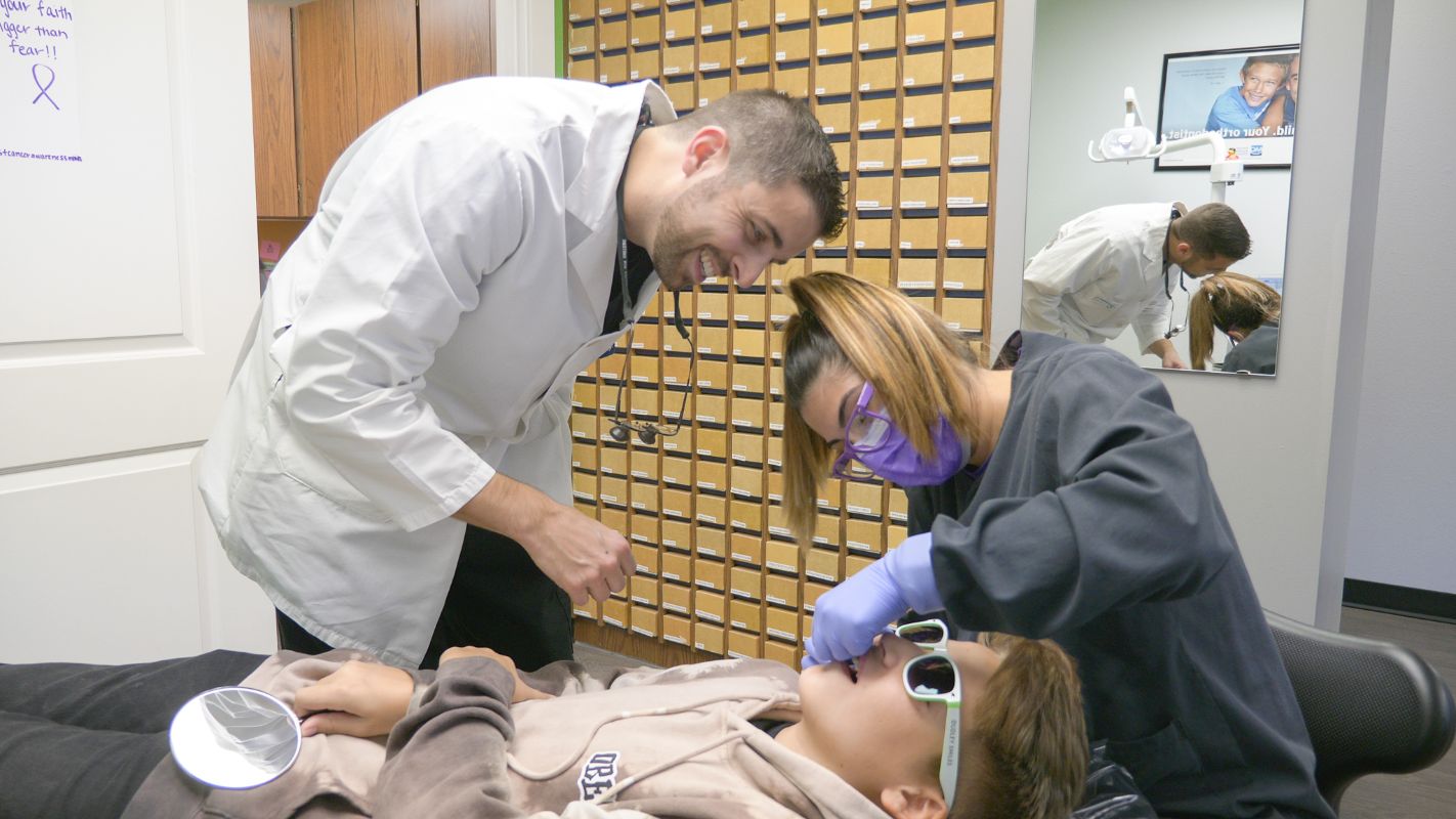 Dr. Dudley looking at a patient's teeth