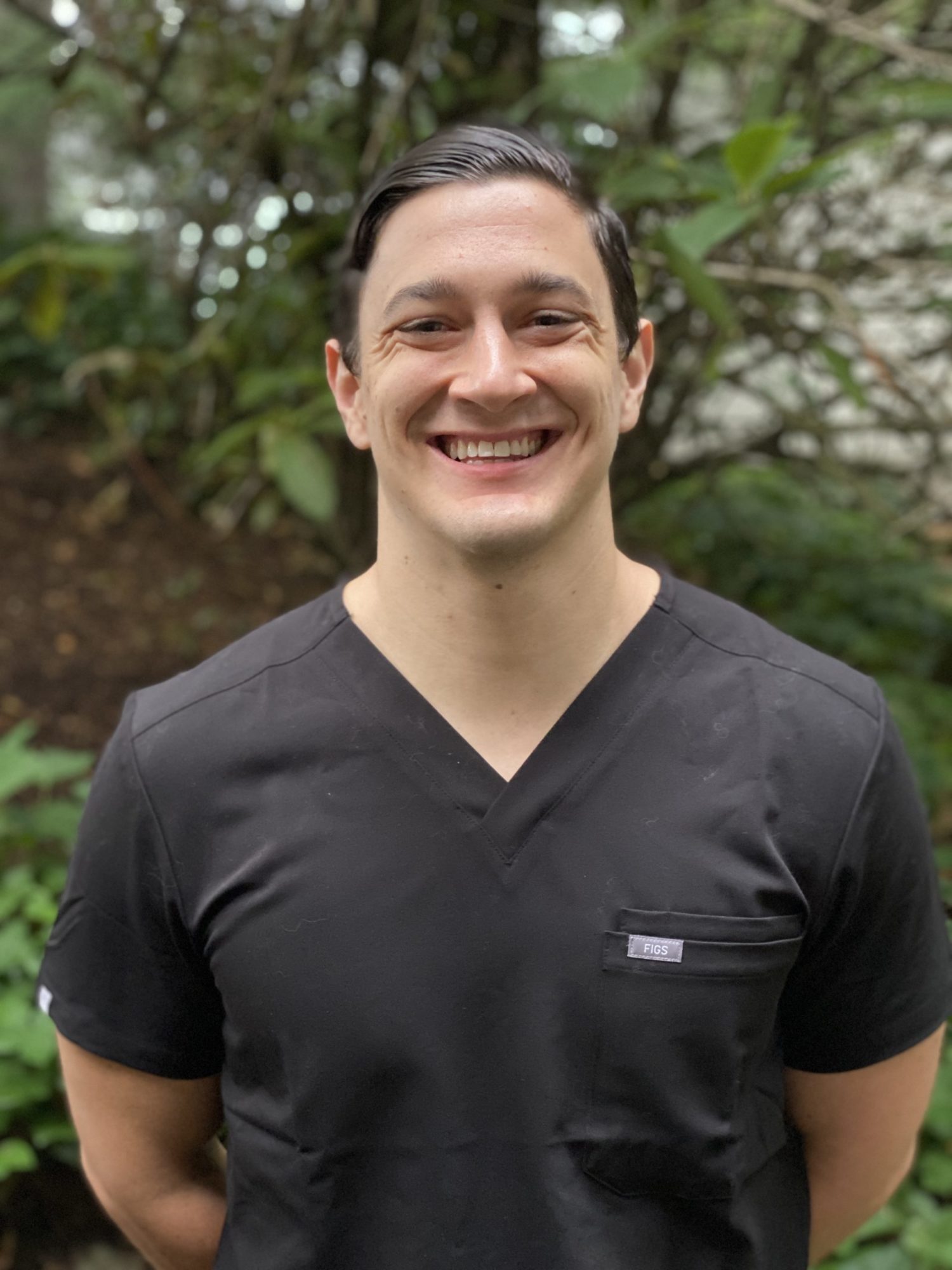 Orthodontist Dr. Cameron Freelove from Dudley Orthodontics smiling in a black shirt.